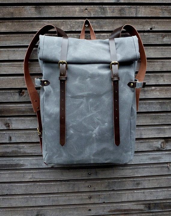 Waxed canvas backpack with roll to close top and vegetable tanned leather shoulderstrap and back reinforcement